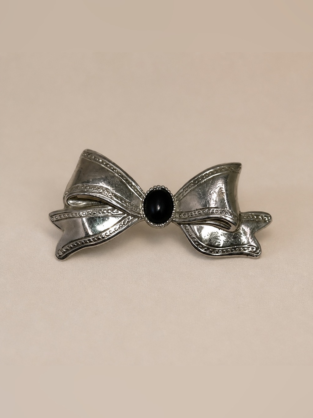 Silver Tone Bow Brooch with Black Center